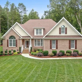 Front yard landscaping with trimmed shrubs and fresh mulch